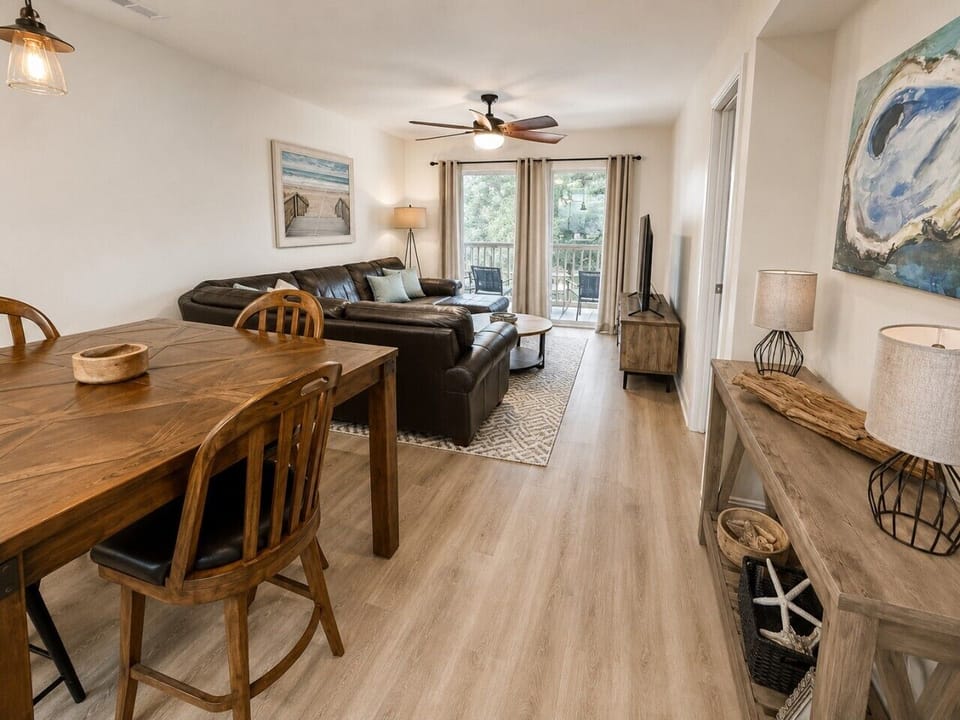 Welcome to the heart of your Pawleys Island getaway, where every space flows effortlessly from one to the next. Share meals around the dining table, unwind in the comfortable living room, or open the balcony doors and enjoy peaceful views overlooking True