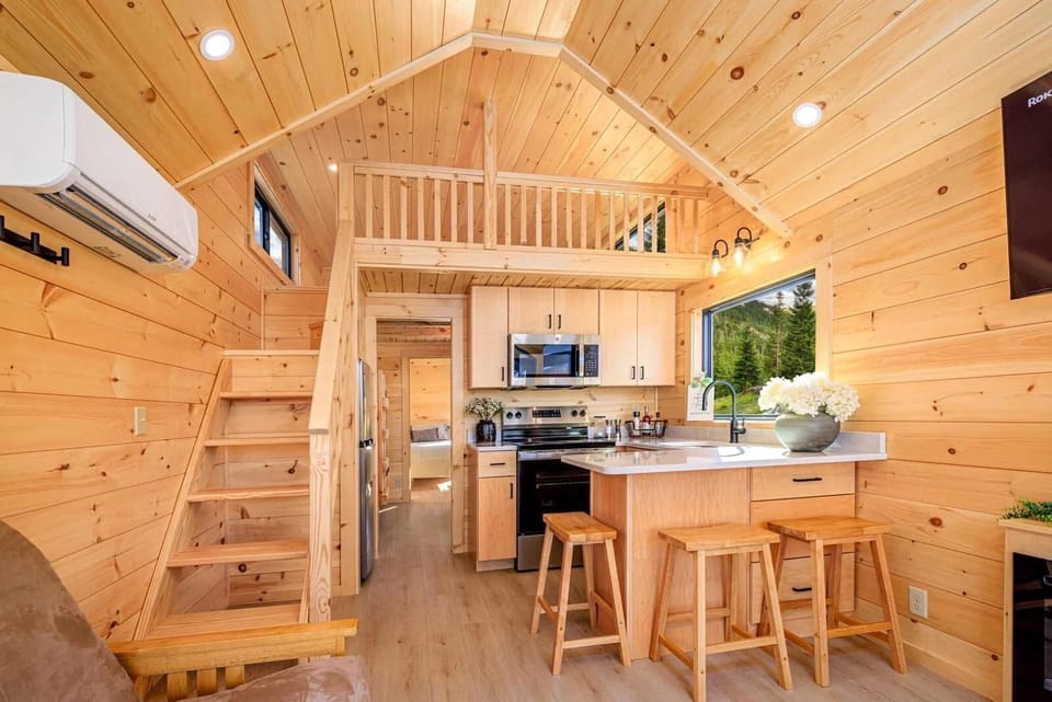 Cozy cabin kitchen with loft and natural wood charm