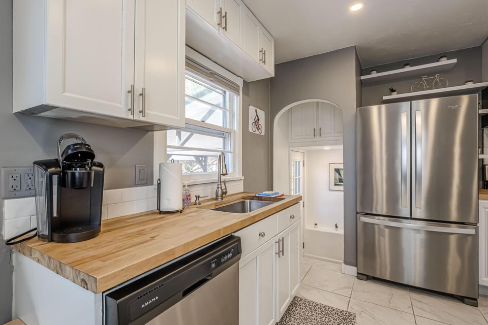 Bright, modern kitchen with stainless steel appliances and natural light