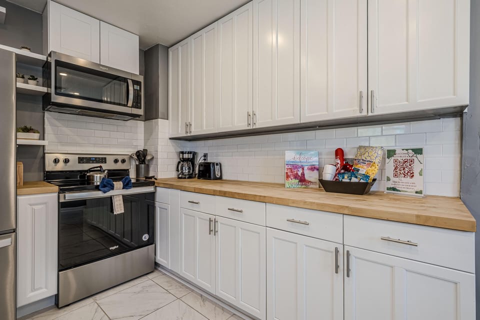 Bright, modern kitchen with stainless steel appliances and ample counter space