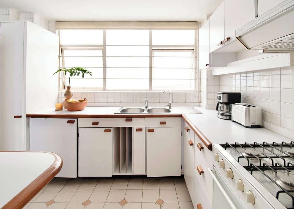 Sunlight pours through the windows, creating the perfect setting for slow mornings with coffee and breakfast.