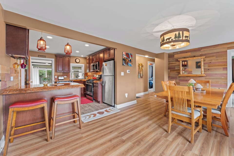 Open kitchen with granite & stainless, rustic dining and cozy bar seating