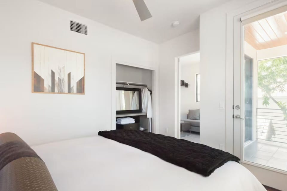 2nd floor bedroom with a small closet and patio access. Comfortable California king bed with soft linens and a quiet space to unwind.