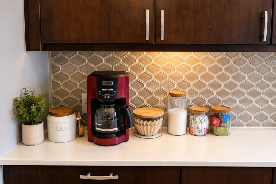 Stylish kitchen coffee station with organized amenities and warm lighting