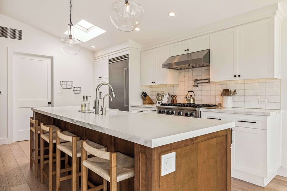 A well-appointed kitchen with a spacious island, clean finishes, and ample seating for gathering and dining.