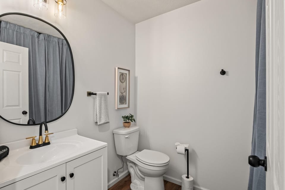 Clean bathroom with compact vanity, toilet, and modern finishes.