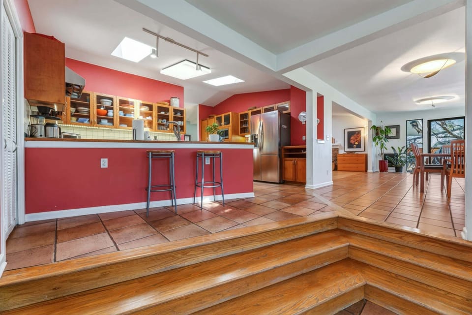 Fully equipped kitchen with stainless steel appliances and bar seating for 2
