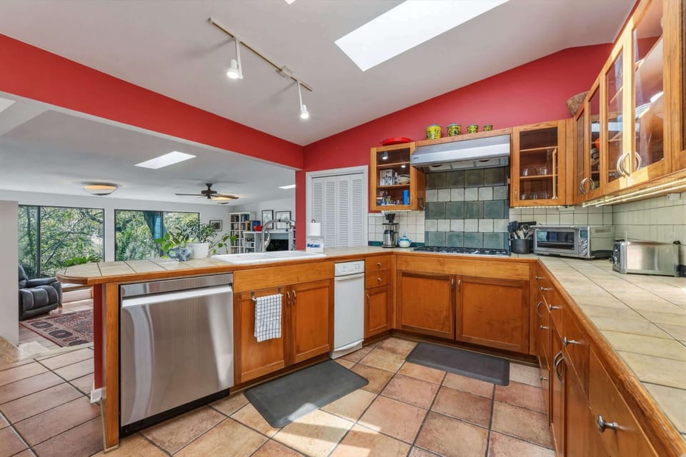 Fully equipped kitchen with stainless steel appliances and bar seating for 2