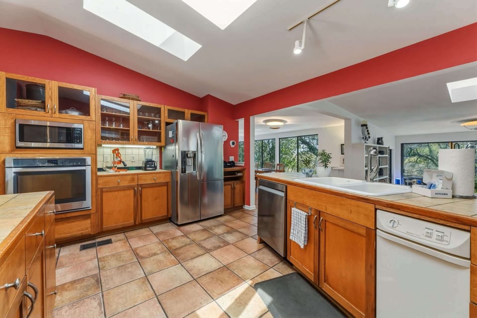 Fully equipped kitchen with stainless steel appliances and bar seating for 2