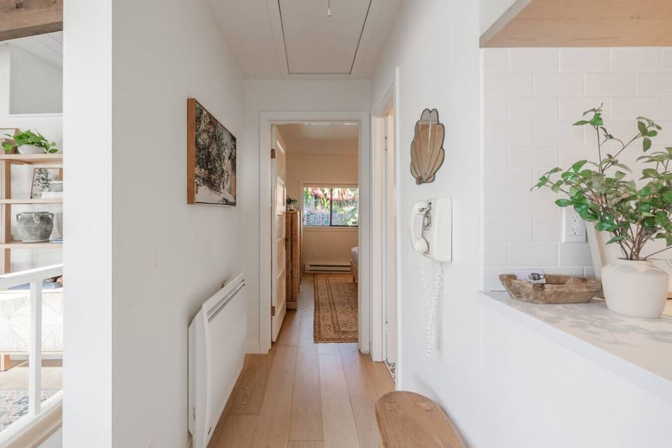 Welcoming entryway with thoughtful decor, lush greenery, and natural light