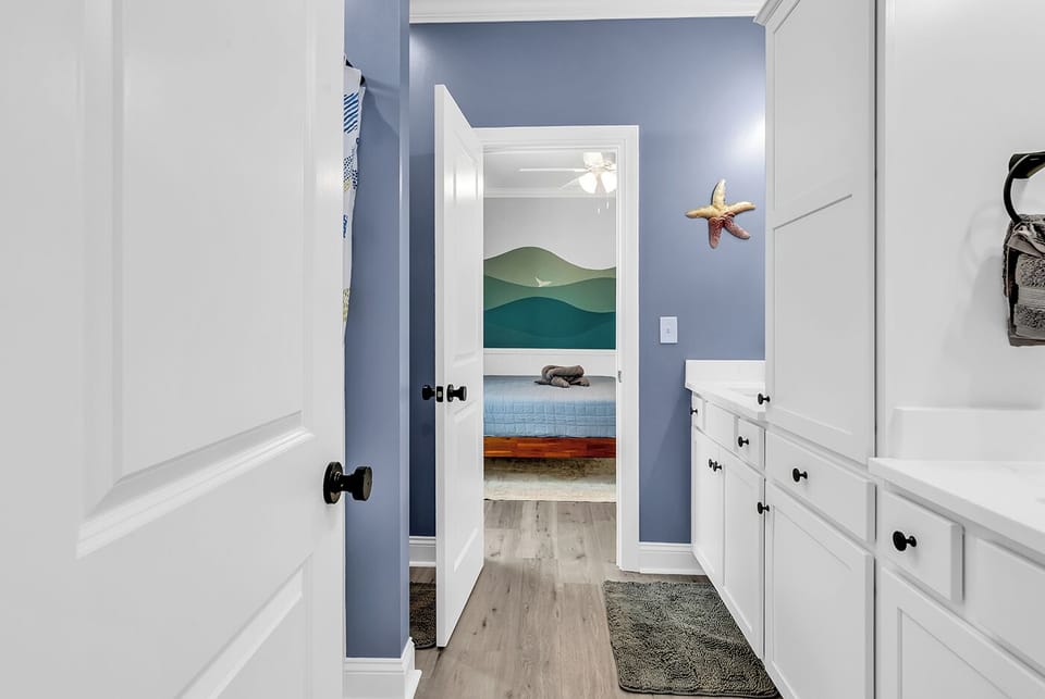 Jack and Jill bath with dual sinks looking at kids room