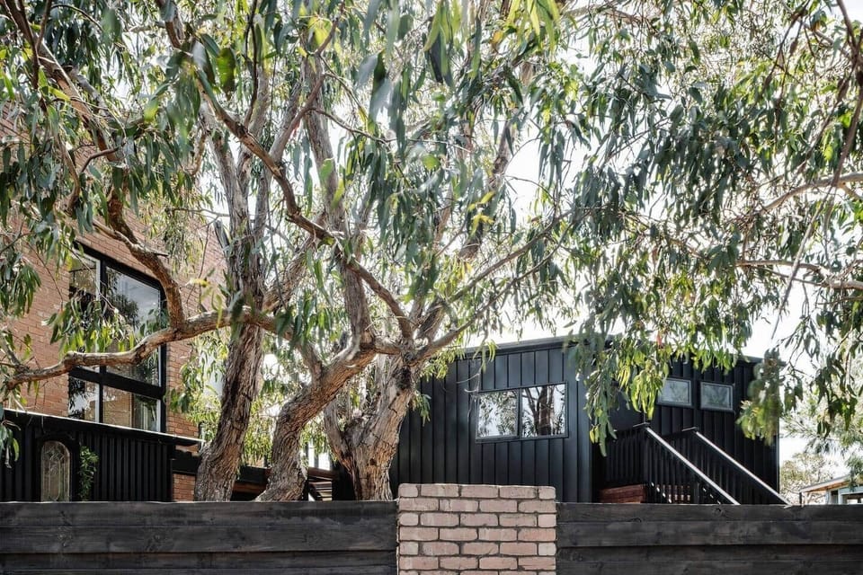 Private studio with separate entrance and private yard – main residence in background.
