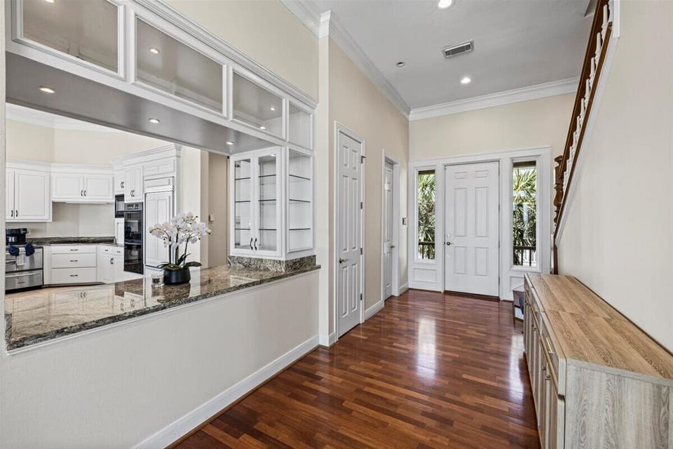 Bright kitchen with breakfast bar, modern appliances, and coastal finishes