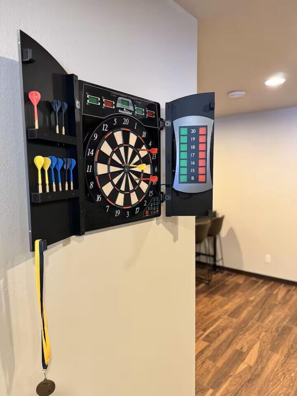 Electronic dart board in basement area