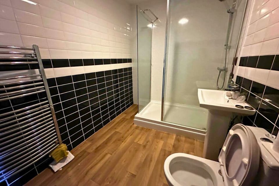 A clean and spacious bathroom with a walk-in shower, modern fittings, and everything you need for a comfortable stay.