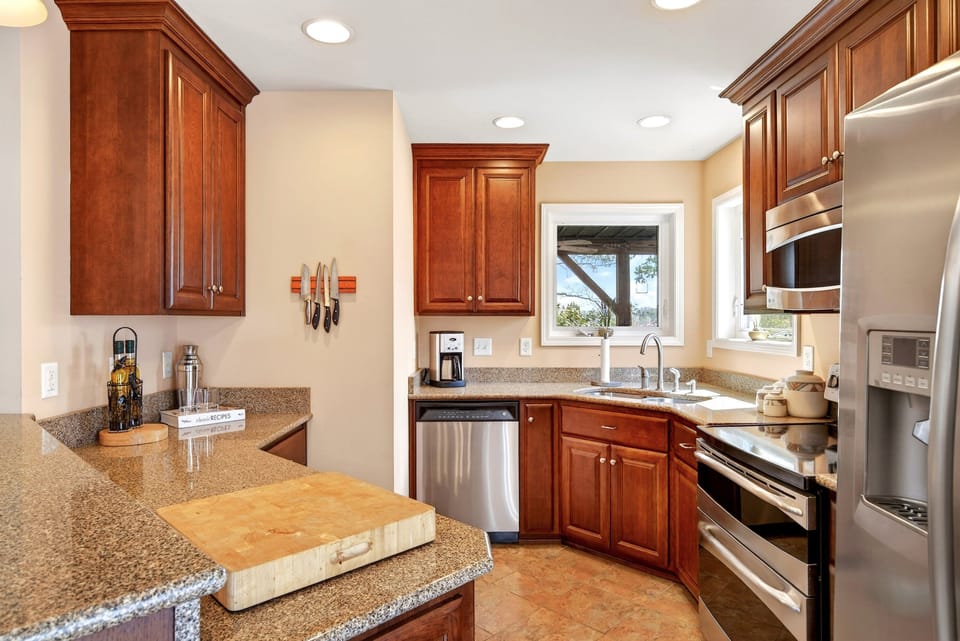 Kitchen with island seating for 2, dishwasher, and drip-style coffee maker