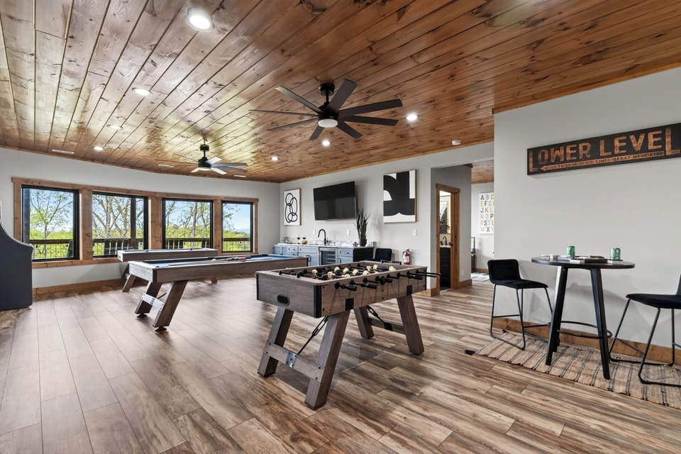 Game room featuring air hockey, a foosball table, and a pool table.