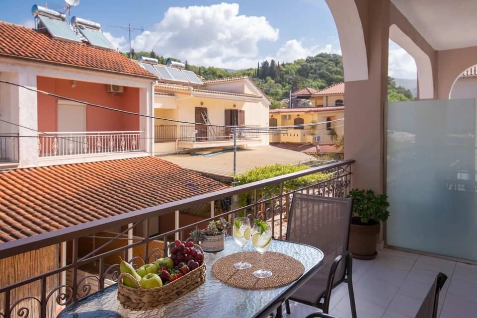 Balcony overlooking traditional rooftops and scenic surroundings, offering a peaceful outdoor space to unwind and enjoy the authentic charm of the area