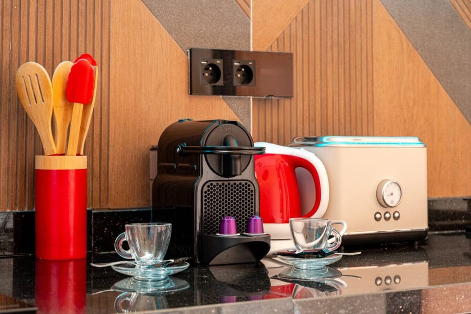 Appareils modernes : réfrigérateur, micro-ondes, four, plaques de cuisson.