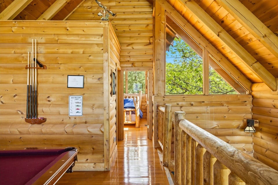 Challenge friends to pool games in your cozy log cabin loft, where rustic charm meets entertainment.