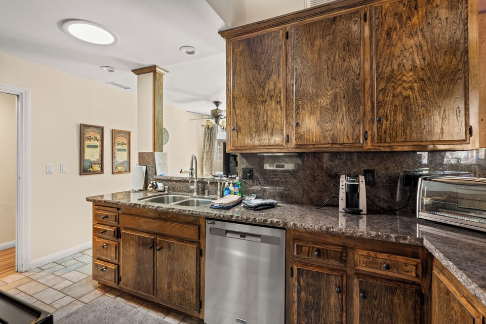 Full Kitchen - The open layout includes a full kitchen, dining area, and a bar space perfect for gathering with everything you need to cook amazing meals.
