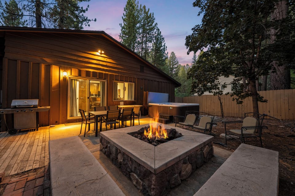 Backyard with Hot Tub and Fire Pit - Step outside to enjoy the large enclosed yard, ideal for soaking in the hot tub, grilling, or enjoying evenings by the fire pit.
