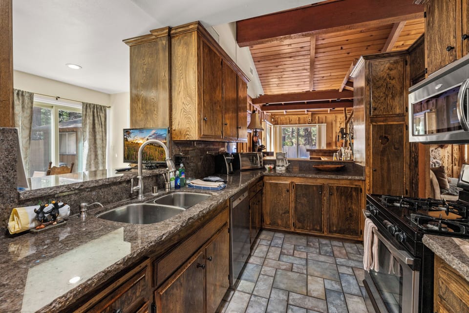 Full Kitchen - The open layout includes a full kitchen, dining area, and a bar space perfect for gathering with everything you need to cook amazing meals.
