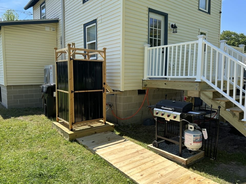 Great outdoor space, rear deck, grill, and outdoor shower