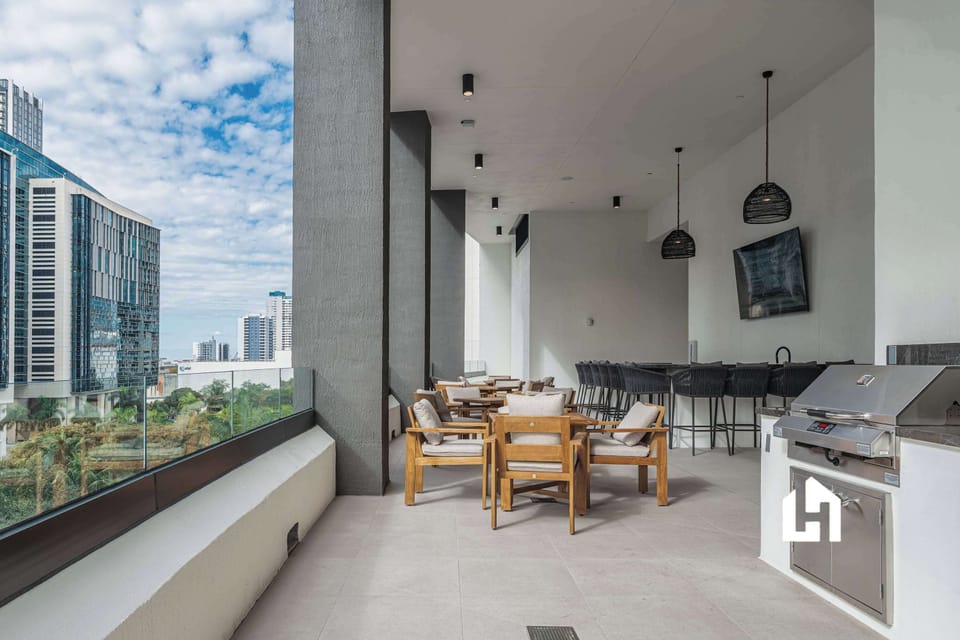 Rooftop BBQ grill and dining area with stunning Downtown Miami skyline backdrop

