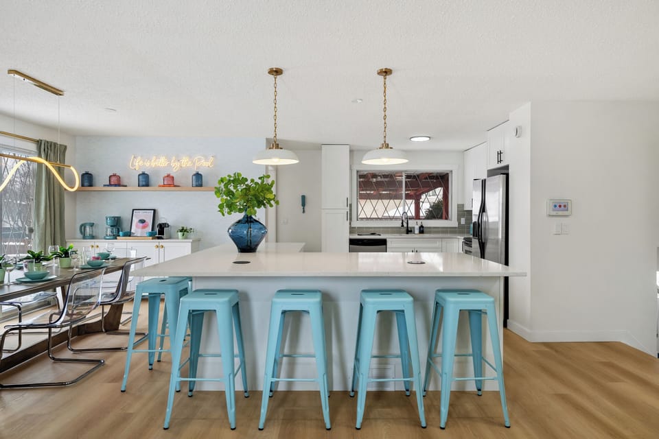 Pull up a stool at the island. There's room for everyone between the bar seats & the dining table behind you.