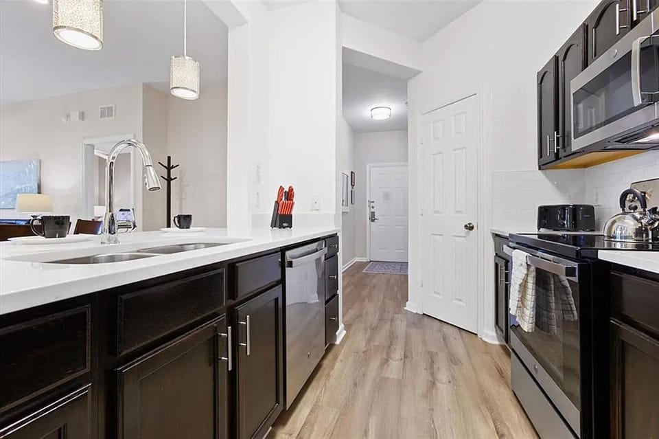Kitchen with stainless steel appliances and quartz countertops
