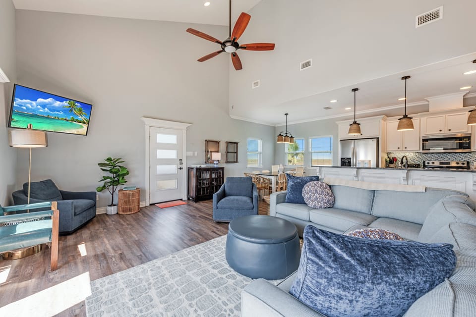 Unwind in your spacious open-concept living area where plush seating and modern comfort meet coastal style.