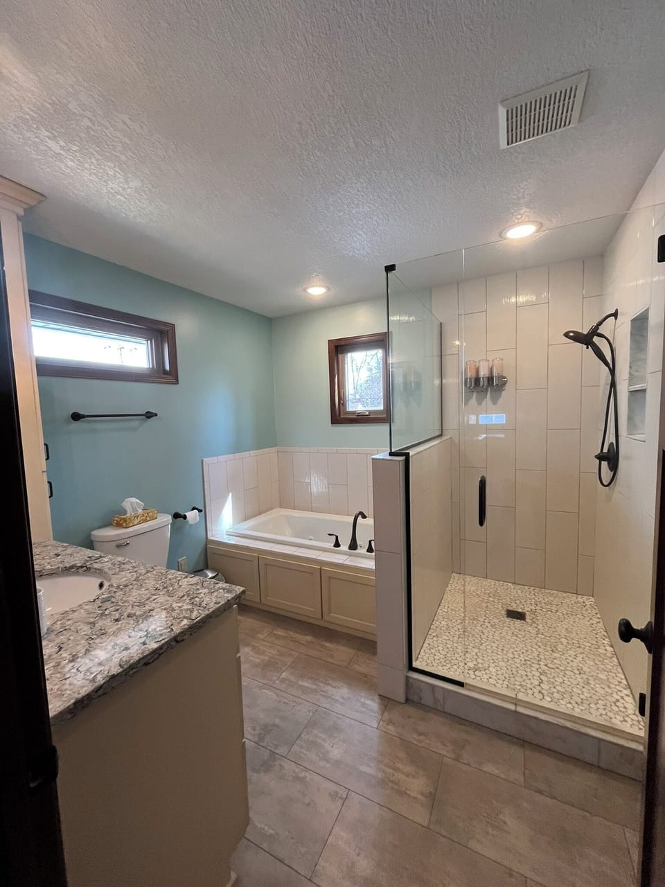 Upper level bathroom with whirlpool tub and walk-in shower.
