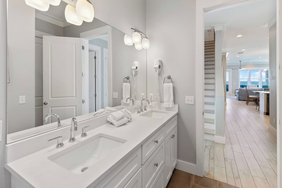 Refresh in your elegant dual-sink bathroom with modern fixtures, plush towels, and beautiful natural light flowing throughout the space.