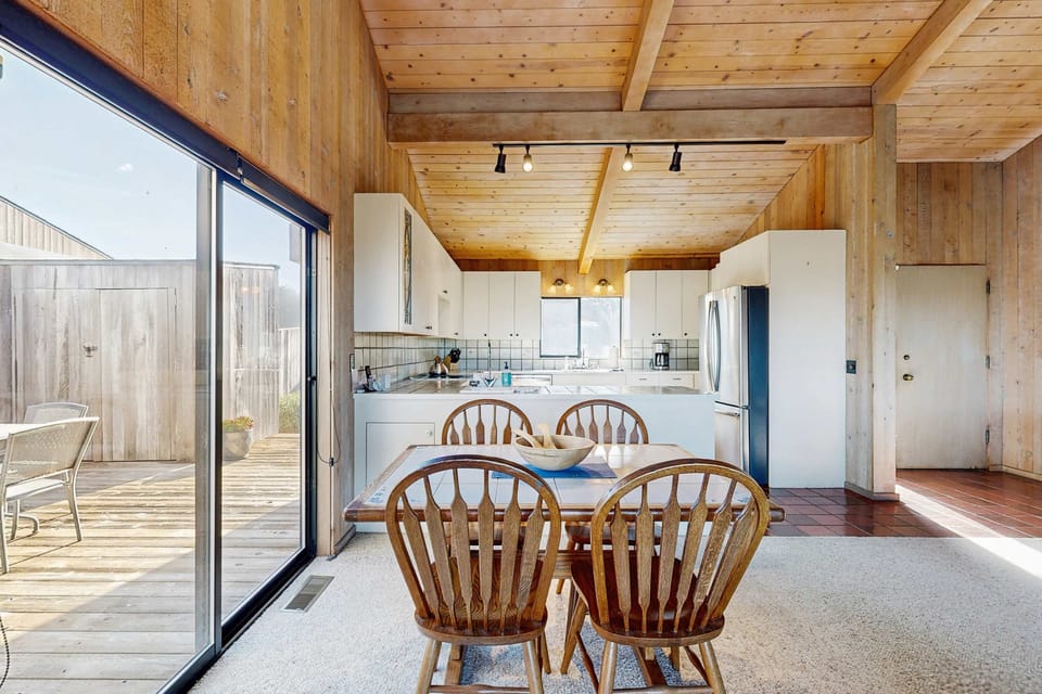 Morning light pours through the sliding glass door as you settle in at the dining table -- the courtyard and grill are just steps away.
