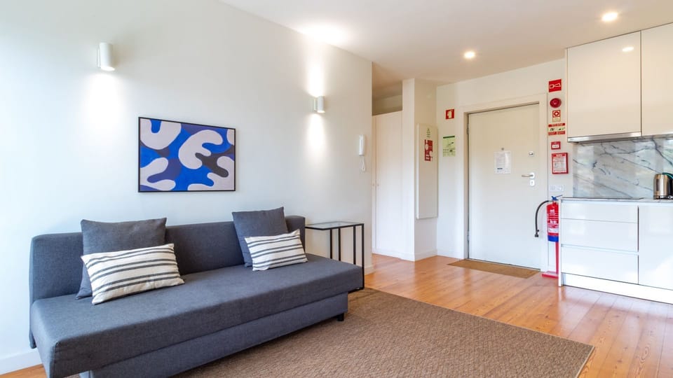 Unwind in the inviting living area, which flows seamlessly into a compact and modern kitchenette, perfect for preparing simple meals at your leisure. The bright, open layout with stylish decor creates a welcoming and functional space for your stay.