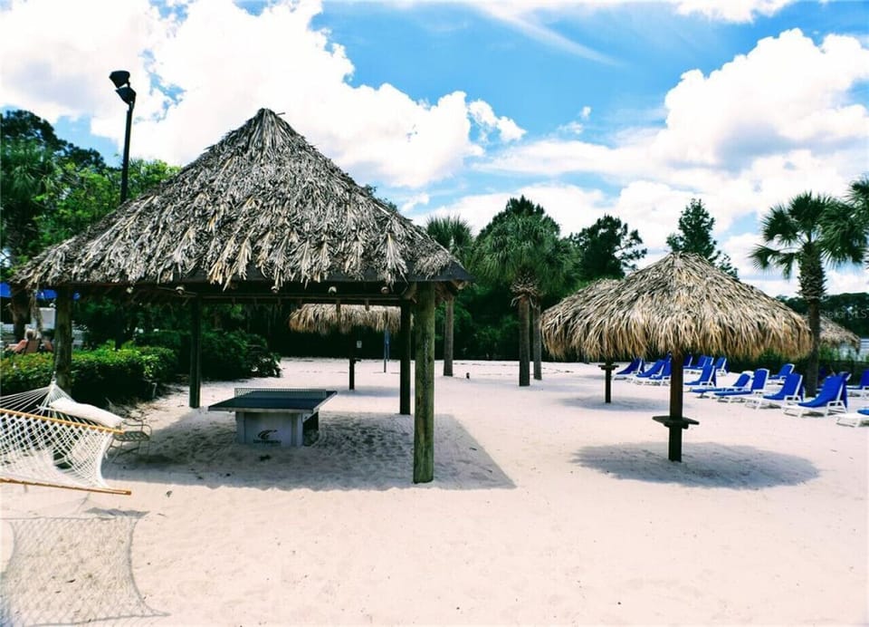 Charming outdoor space with shaded huts and resort-style seating