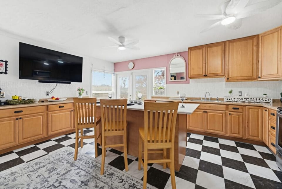 Main House Kitchen | Breakfast Bar Seating | Wall Mounted TV & Window Light