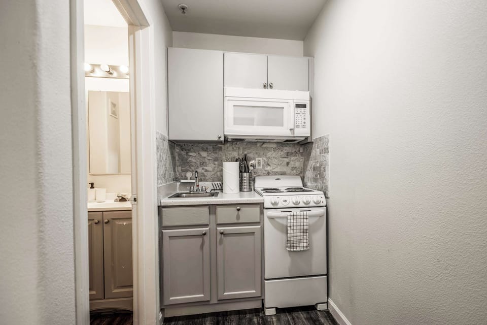 Cozy kitchenette with modern amenities, perfect for quick meals in your private studio retreat.