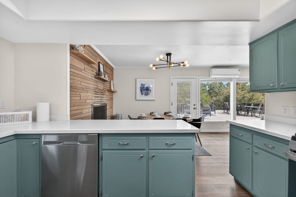 Open-concept kitchen flows seamlessly into the dining and living areas, creating a bright and inviting space perfect for entertaining.