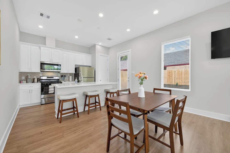 Bright open concept kitchen and dining area with plenty of natural light and contemporary finishes.