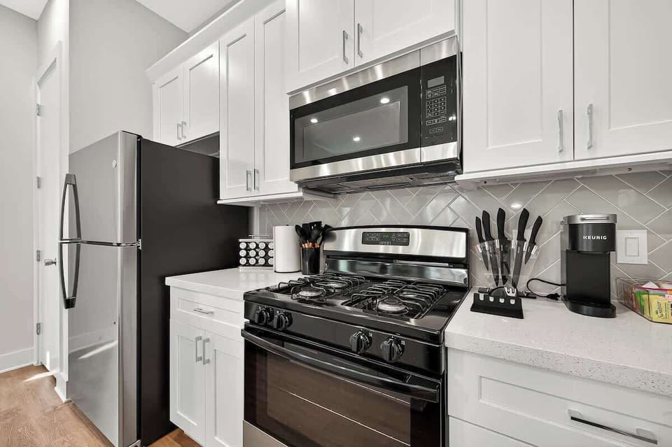 Fully equipped kitchen with modern stainless-steel appliances, Keurig coffee maker, and all the essentials for cooking at home.