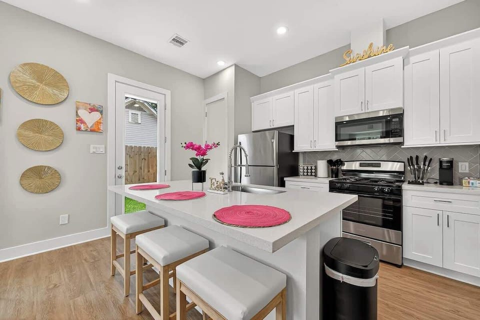 Fully equipped space featuring stainless-steel appliances and a breakfast bar. 
