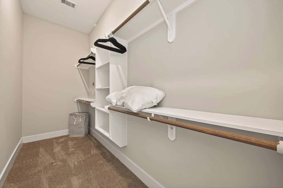 A spacious walk-in closet with built-in shelving and plenty of hanging room for all your travel essentials.