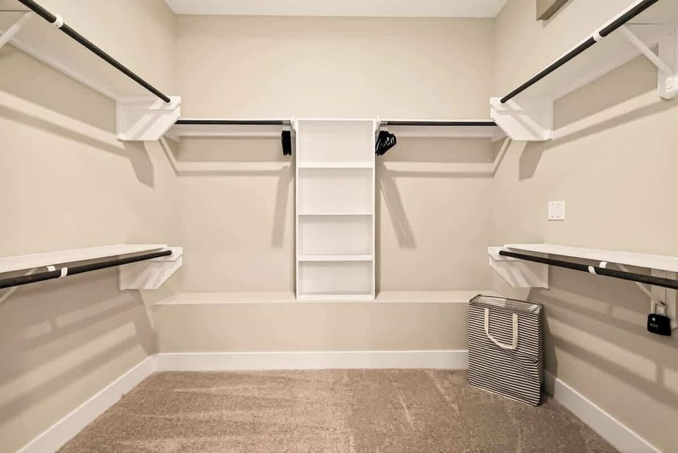 Bright and organized walk-in closet offering ample room for all your belongings.