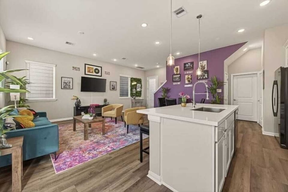 Living Room: Vibrant decor and abundant natural light create the perfect space to unwind and socialize!