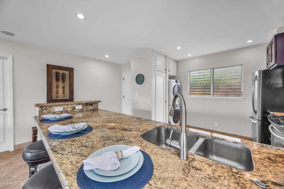 Granite countertops and bar seating—ideal for cooking, dining, and gathering.