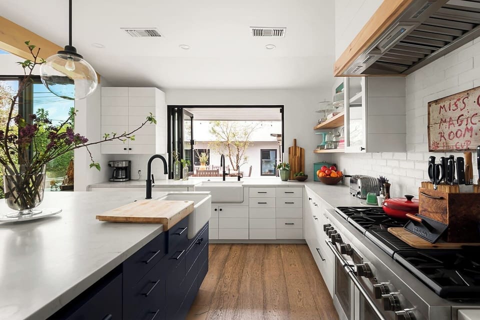 A well-equipped kitchen with a large island, open windows, and everything you need to cook and gather.