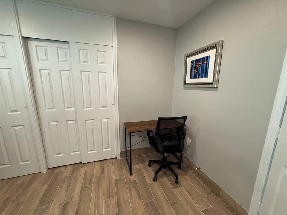 Bedroom 3 has a dedicated workspace with a desk and an ergonomic chair