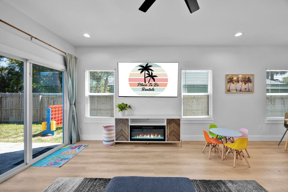 Living Room #1 - large sectional, 75in TV, electric fireplace, board games.